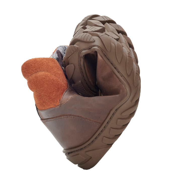 The WALQ Brown Waterproof shoe from ZAQQ Made of brown suede and flexible, sturdy sole is curved in the middle to demonstrate its flexibility and durability. This barefoot shoe is complemented by a contrasting orange fabric lining.