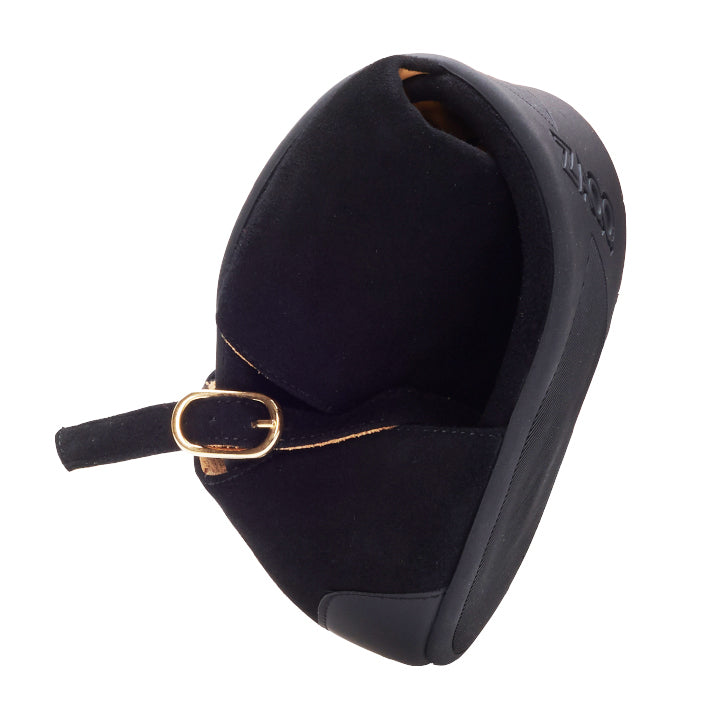 A single black slipper with a thick sole and a small buckled strap at the back stands on a white background. The subtly embossed branding on the side of the sole underlines its elegant design as UQO Black by ZAQQ.