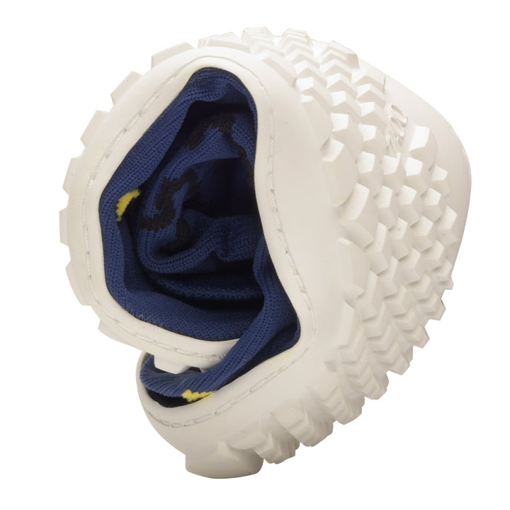 A picture of the white sole of the SOQQ Zodiac Blue from ZAQQ shows its structured tread. This sock shoe is tightly folded to reveal the navy blue interior with yellow accents that emphasize its flexibility and seamless knit fabric design.