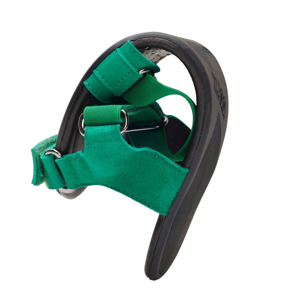 The ZAQQ MIQA Green Sandal, a barefoot sandal with a strap system, is elegantly captured in a mid-curve close-up to highlight its flexibility and design. Their open toe style in green with black straps and sole perfectly embodies comfort and style.