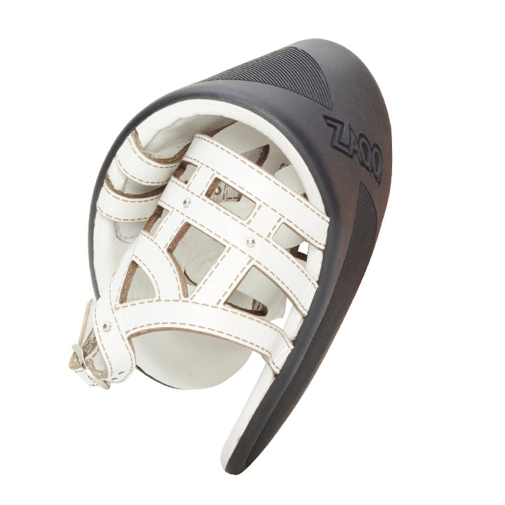 A top view of a single white QANQETA shoe from ZAQQ with black rubber sole and white straps made of premium nappa leather with buckle detail. This barefoot sandal features an open toe and a modern, minimalist design.