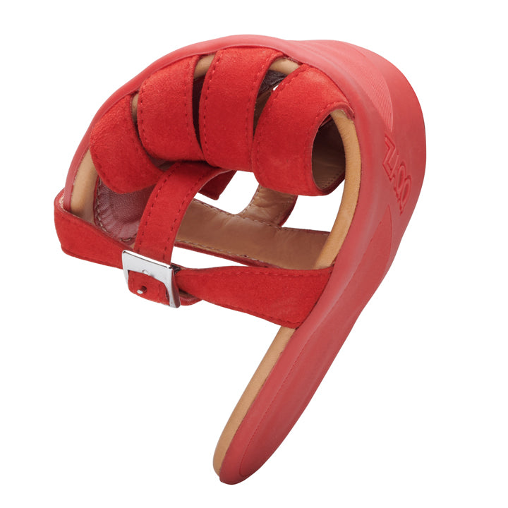 We present the QEIRA Red from ZAQQ: A striking red leather open toe shoe. It features adjustable straps and a padded rubber sole with a side buckle and a unique curved shape that evokes the elegance of a stylish barefoot sandal.