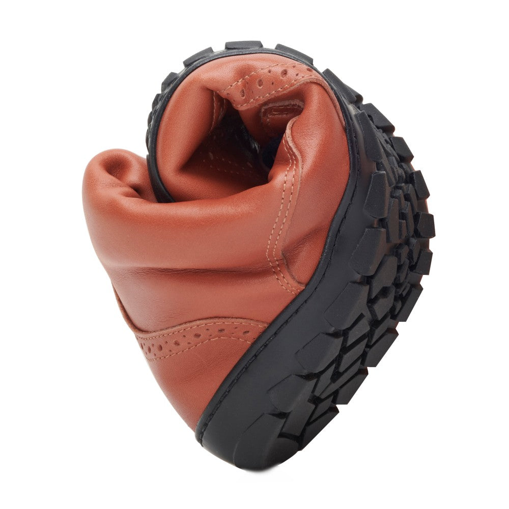 The QUINTIC Winter Brogue Cognac from ZAQQ is expertly crafted from high-quality nappa leather in a warm brown tone and features a flexible black rubber sole that demonstrates its adaptability. The upper has a smooth finish that contrasts with the robust texture of the sole, offering an elegant mix of style and functionality - making it an ideal, versatile winter boot.