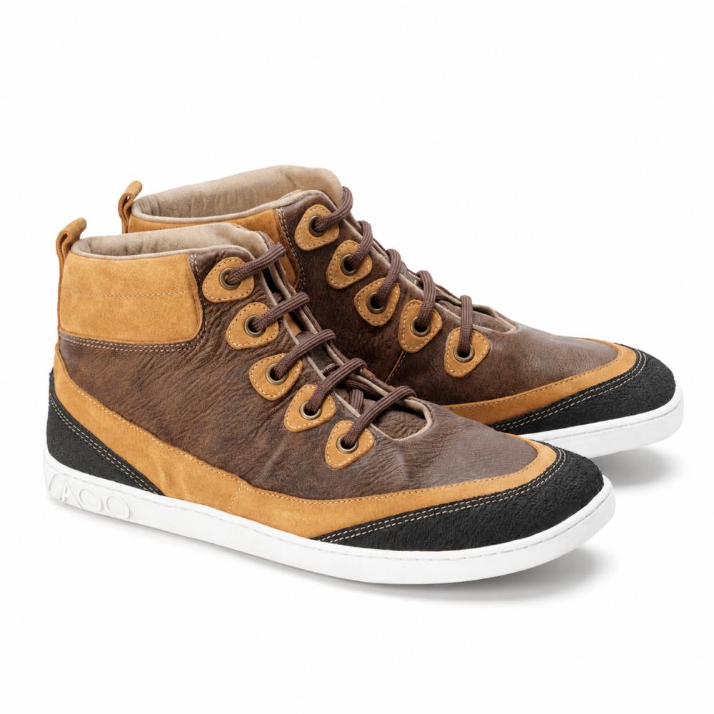 The ZAQQ CINQO Brown High-Top Sneakers captivate with a luxurious nappa leather texture in brown and light brown, enhanced by black accents on the toe cap and heel. These stylish shoes feature white soles, brown laces, and a practical loop at the back for easy carrying.