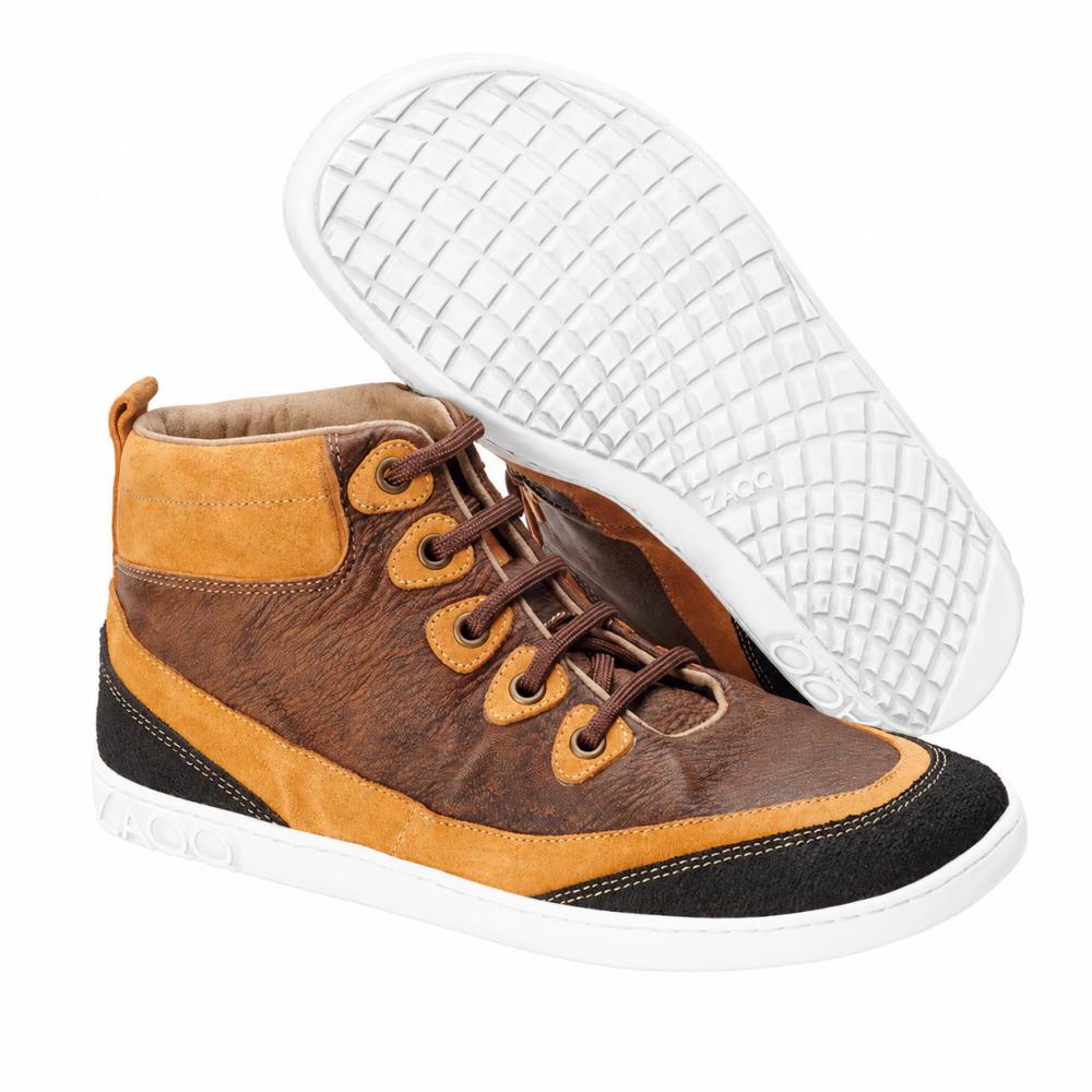 A pair of fashionable ZAQQ CINQO Brown High-Top Sneakers in shades of brown and orange with black accents and a white sole made from supple nappa leather. One shoe stands upright while the other lies on its side, highlighting the textured sole design that embodies the comfort of a barefoot shoe.