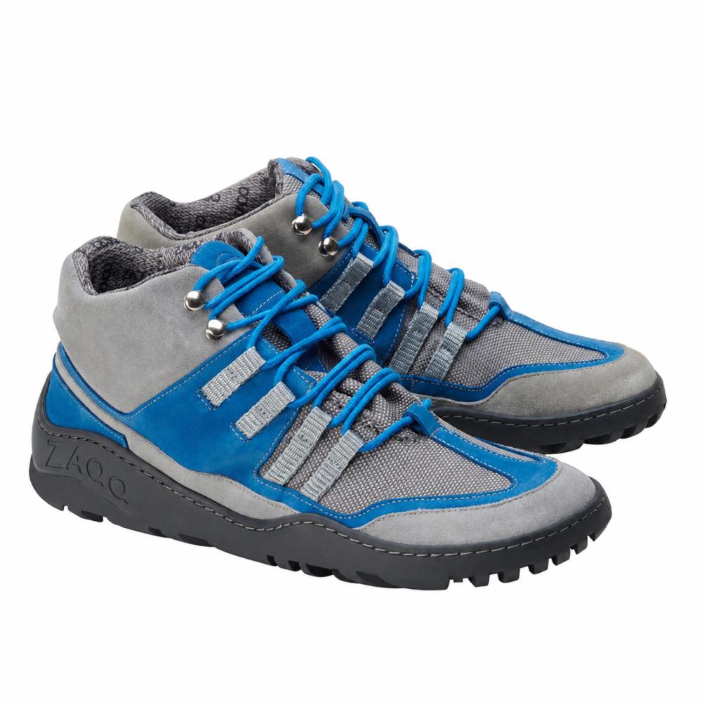We present the ZAQQ ESQAPE Grey Blue Waterproof Sneaker with a sturdy sole and blue laces. These shoes are made from a combination of mesh and leather, offering a sporty look paired with exceptional durability. The waterproof inner membrane ensures your feet stay dry on every adventure.