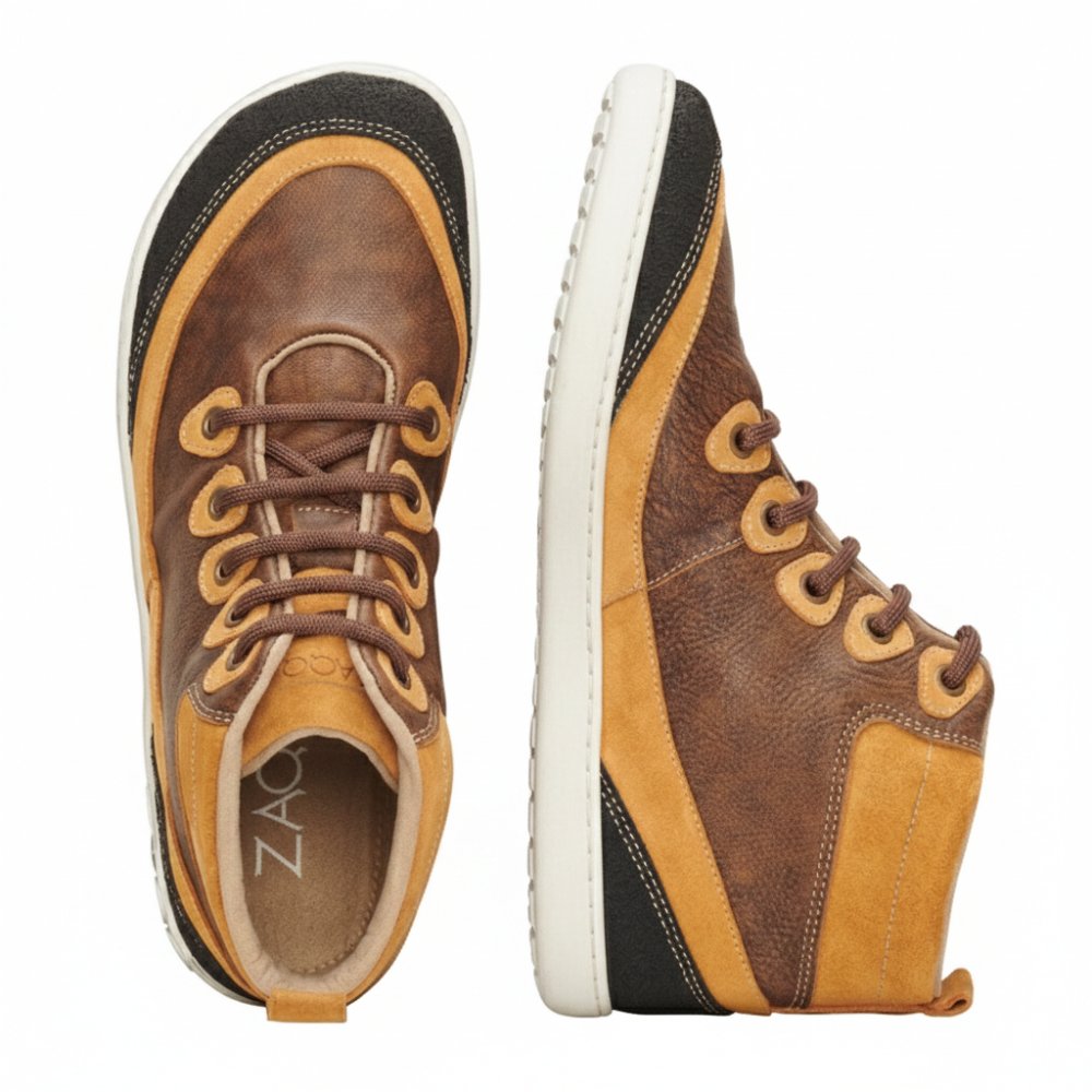 The FRANQY Brown high-top sneakers offer exceptional comfort with their stylish brown-brown design and white soles. One shoe is seen from above while the other has the brand name ZAQQ on the side of the sole. These barefoot shoes are equipped with brown laces for lacing.