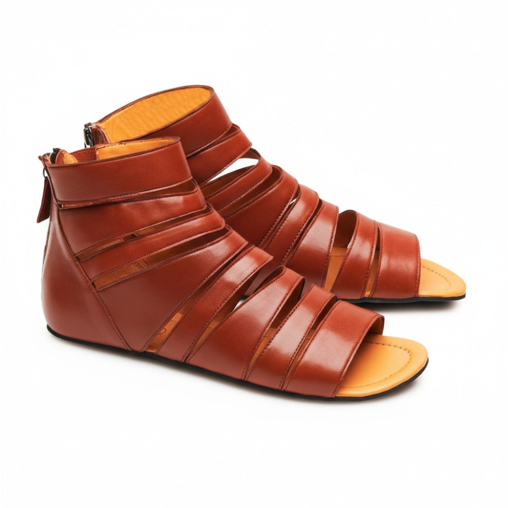 The GLADIQ Cognac from ZAQQ are a stunning pair of brown gladiator sandals made from luxurious nappa leather. Featuring multiple straps and a convenient back zip closure, these sandals are designed with an open toe and flat soles to seamlessly combine style and comfort.