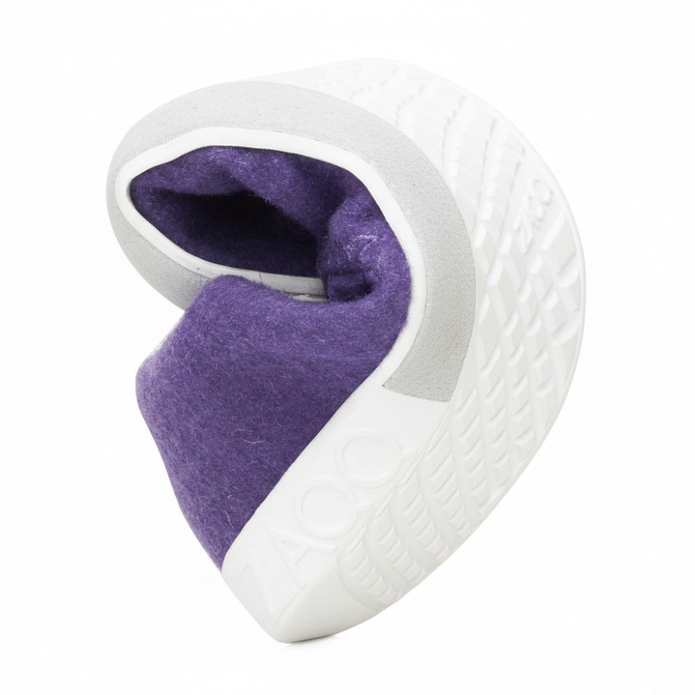 Introducing LIQE Purple from ZAQQ, a small, elaborately designed sculpture reminiscent of a fortune cookie. It has a textured gray exterior with a bright purple interior and detailed patterns reminiscent of the grip of the barefoot sole and the text "ZAOO".