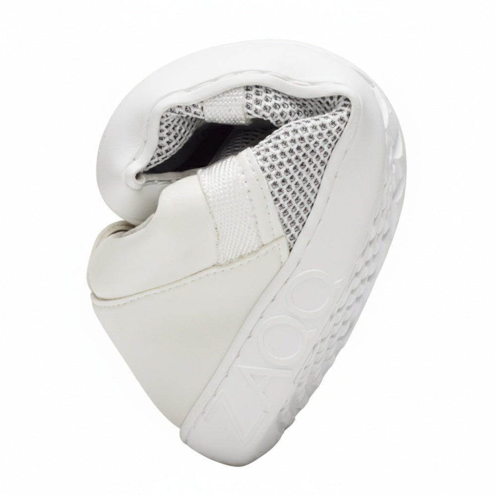 The MCQARTER White barefoot shoe from ZAQQ with a structured sole and breathable mesh fabric is curved in a circle, showing its flexibility and comfort. The brand name ZAQQ is printed on the side of the sole.