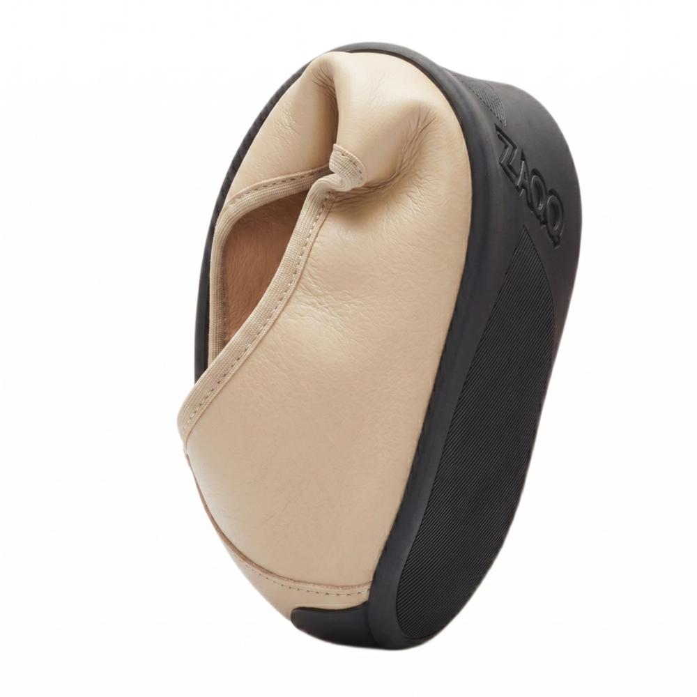 A stylish, abstract sculpture with a beige, curved shape reminiscent of a work of art by ZAQQ QARMA reminds. The textured black exterior provides contrast. This sleek design exudes elegance and captures the movement and flow, similar to a dancer in motion.