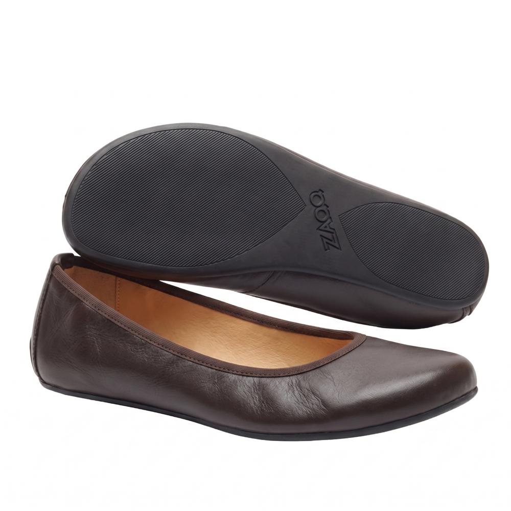 A pair of elegant dark brown QARMA ballet flats from ZAQQ, with one shoe laying on its side to reveal the sole and the other standing upright to highlight the rounded toe and low-cut design. The light brown lining gives these barefoot ballet flats an elegant touch.