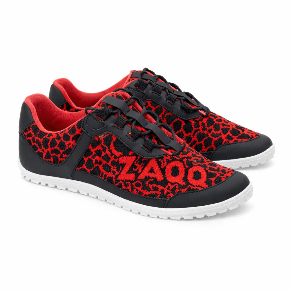 We present the QASEY Red from ZAQQ: These casual sneakers feature a red and black mesh upper with black laces, complemented by a flexible rubber sole. The design is completed with white soles and a red lining, while the brand name ZAQQ prominently displayed on the side.