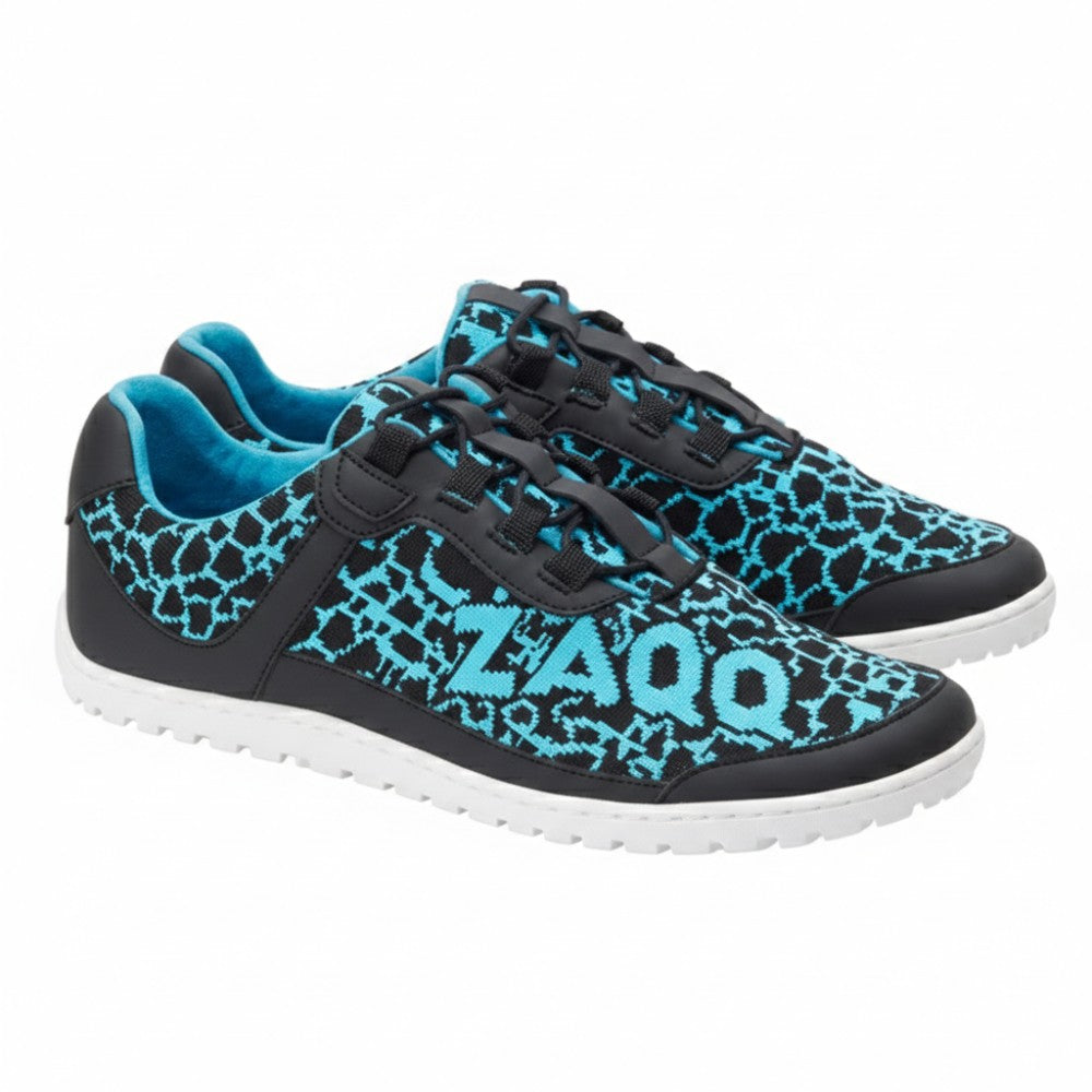 The QINGSTON Turquoise shoes from ZAQQ are black and turquoise sports shoes with a unique geometric pattern made of vegan mesh. The brand name ZAQQ is pictured on the side of each shoe. They come with black laces and white soles, making them the ideal choice for vegan running enthusiasts.
