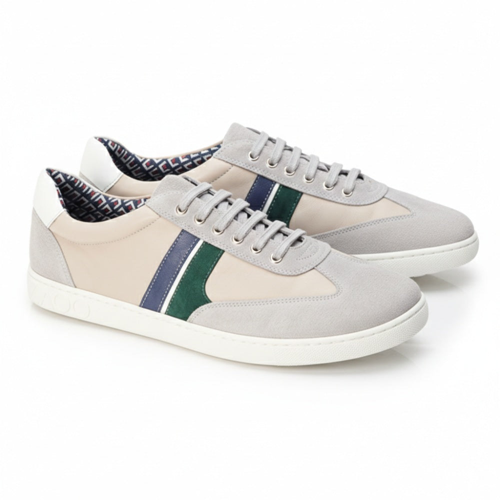 Introducing the QLAUDE Gray Sneakers from ZAQQ: These fashionable casual shoes have a light gray suede exterior decorated with dark blue and green stripes. The inside is lined with a stylish pattern while the white ZAQQ Sneaker sole with its subtle decorative textures gives a contemporary flair. Ideal for every occasion!