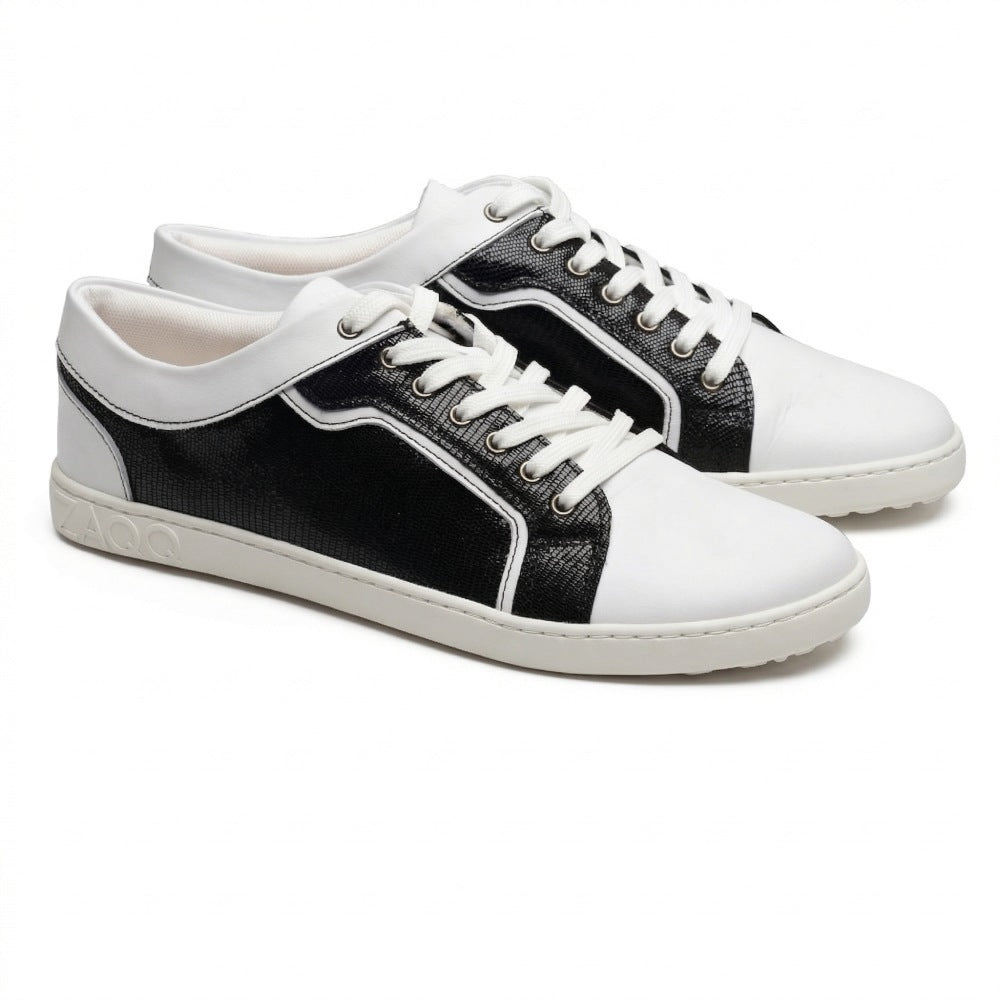 The QODY White Sneakers from ZAQQ impress with their minimalist yet chic design, which combines structured black elements with smooth white surfaces. Crafted from premium nappa leather, they feature white laces and white soles, offering an ideal mix of comfort and elegance for any casual occasion.