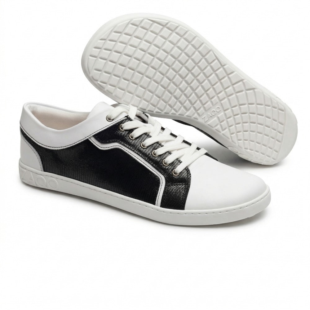 The ZAQQ QODY White sneakers impress with their stylish design with a white sole and black structured side panels made of high-quality nappa leather. They feature white laces and toe box and the ZAOO logo on the side. The eye-catching sole pattern gives these sneakers an eye-catching, modern touch.