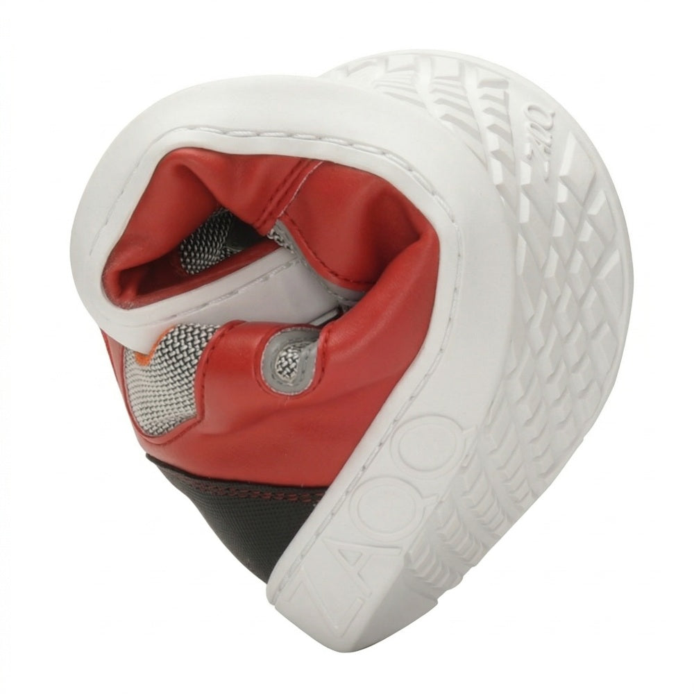 A ZAQQ QOPA Red sneaker with red and black design and white sole is cleverly folded in half to form a heart shape. The flexible sole and the elaborate tread pattern of the barefoot shoe are visible and show its flexibility and distinctive design.