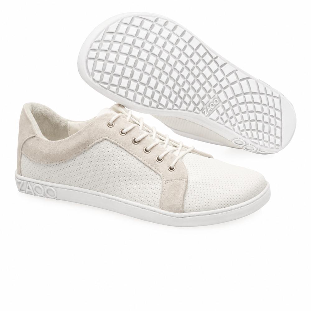 The ZAQQ QORE Low White Sneakers, crafted from high-quality nappa leather, exude sophistication with their laces and dotted perforations. One has a flat sole, while the other features a textured waffle sole, providing both style and comfort with every step.