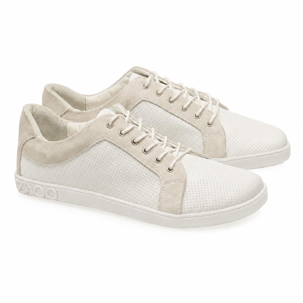 We present the QORE Low White Sneakers from ZAQQ: elegant white casual shoes with beige accents and white laces. These sneakers, made from high-quality nappa leather with a perforated texture, feature a barefoot shoe-inspired design and have a light sole that offers unmatched comfort and style.