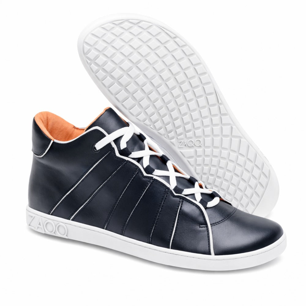 The QQQ Mid Black White high-top sneakers from ZAQQ are made from smooth nappa leather and feature white laces and textured grid pattern soles. An orange lining adds a pop of color while the brand name ZAQQ prominently featured on the outsole. These shoes offer a sophisticated style combined with a barefoot feel.