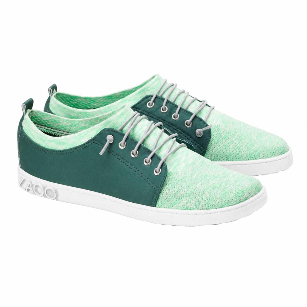 We present the QRIS Green Sneaker from ZAQQ: a stylish pair of mint green casual shoes with a white sole, dark green accents, and white laces. These sneakers feature a modern, sporty design and are perfect for any adventure.