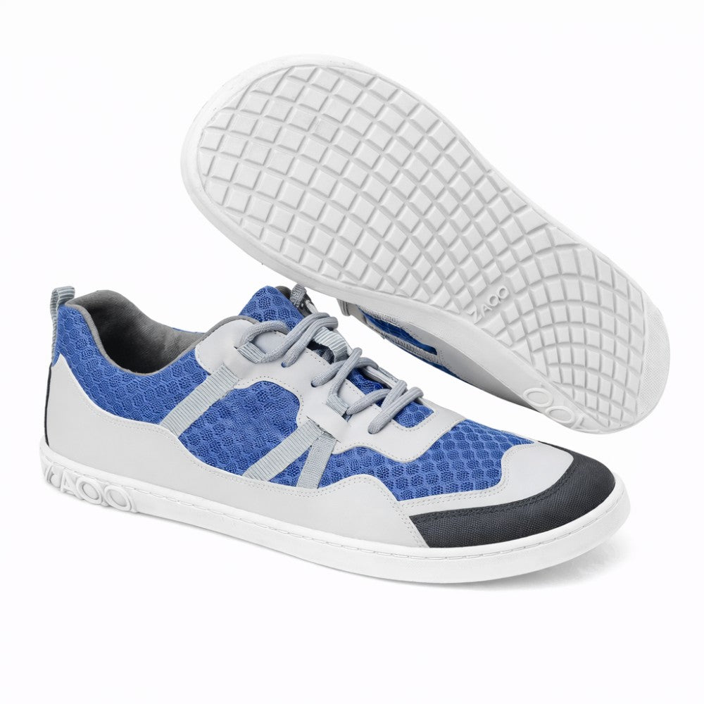 Introducing the SQOTT Blue from ZAQQ, a stylish pair of casual sneakers with a unique honeycomb pattern in shades of blue and gray. The breathable design is enhanced with a textured grid pattern for superior support. With white and gray accents and matching laces, these shoes are perfect for everyday wear.