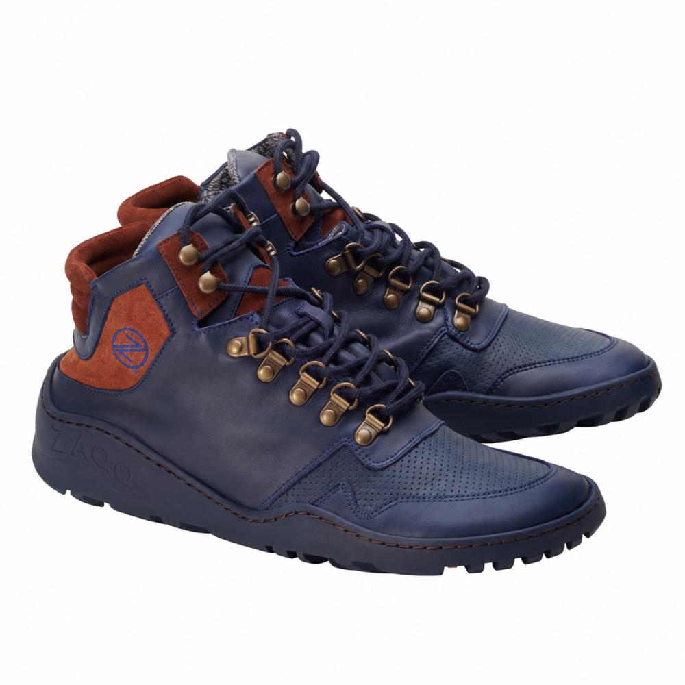 We present the waterproof VAQATION Cognac sneakers from ZAQQ, featuring stylish high-top designs in navy blue and brown with a robust TERRA sole and metal eyelets. These barefoot shoes are distinguished by leather accents and contrasting textures, offering a modern, sporty look that is perfect for outdoor adventures.